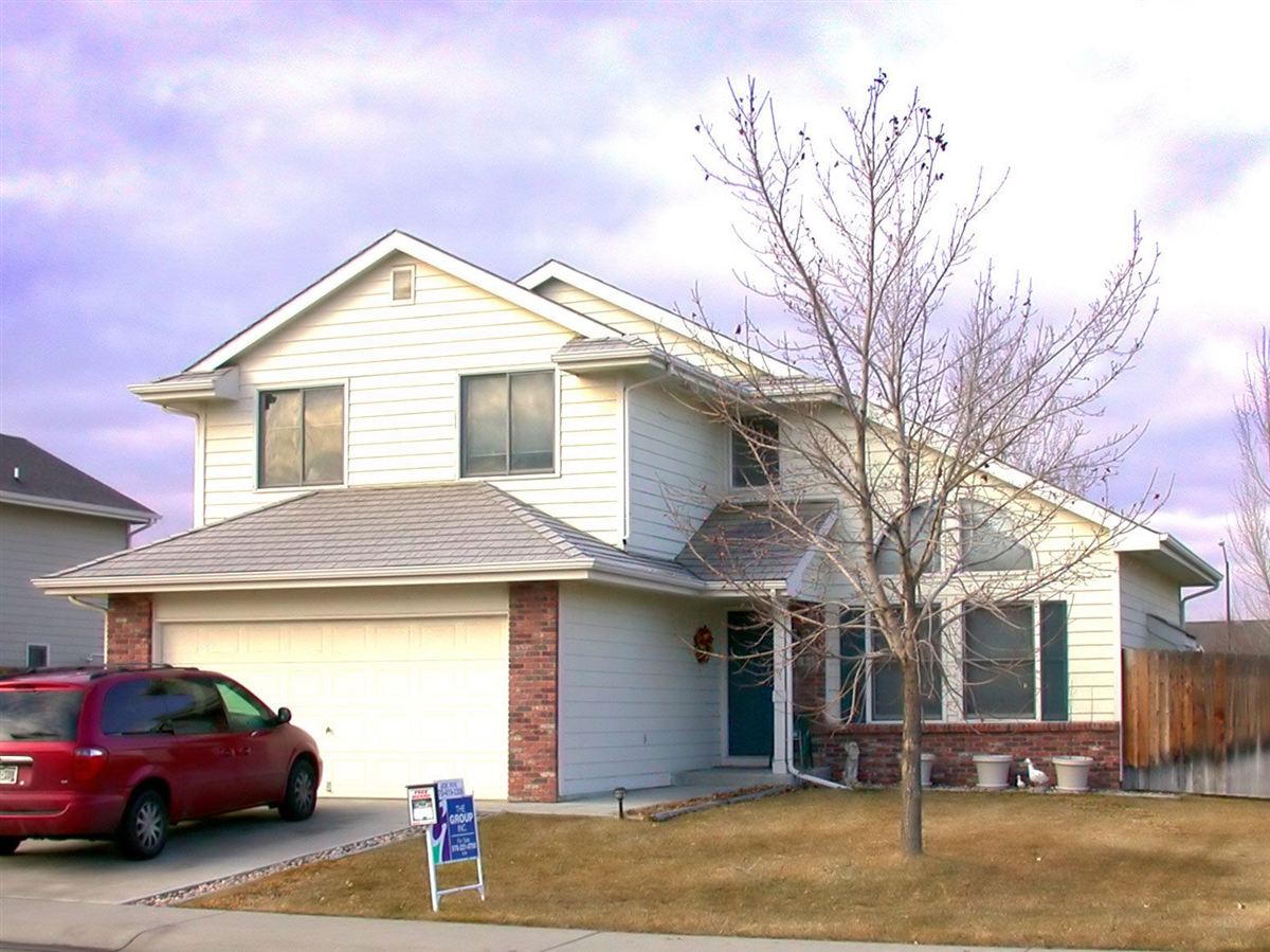 A suburban family home with a front lawn